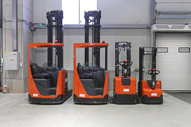 row of forklifts in warehouse