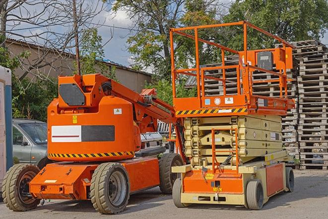 warehouse forklift in action with neatly arranged pallets in Hendersonville